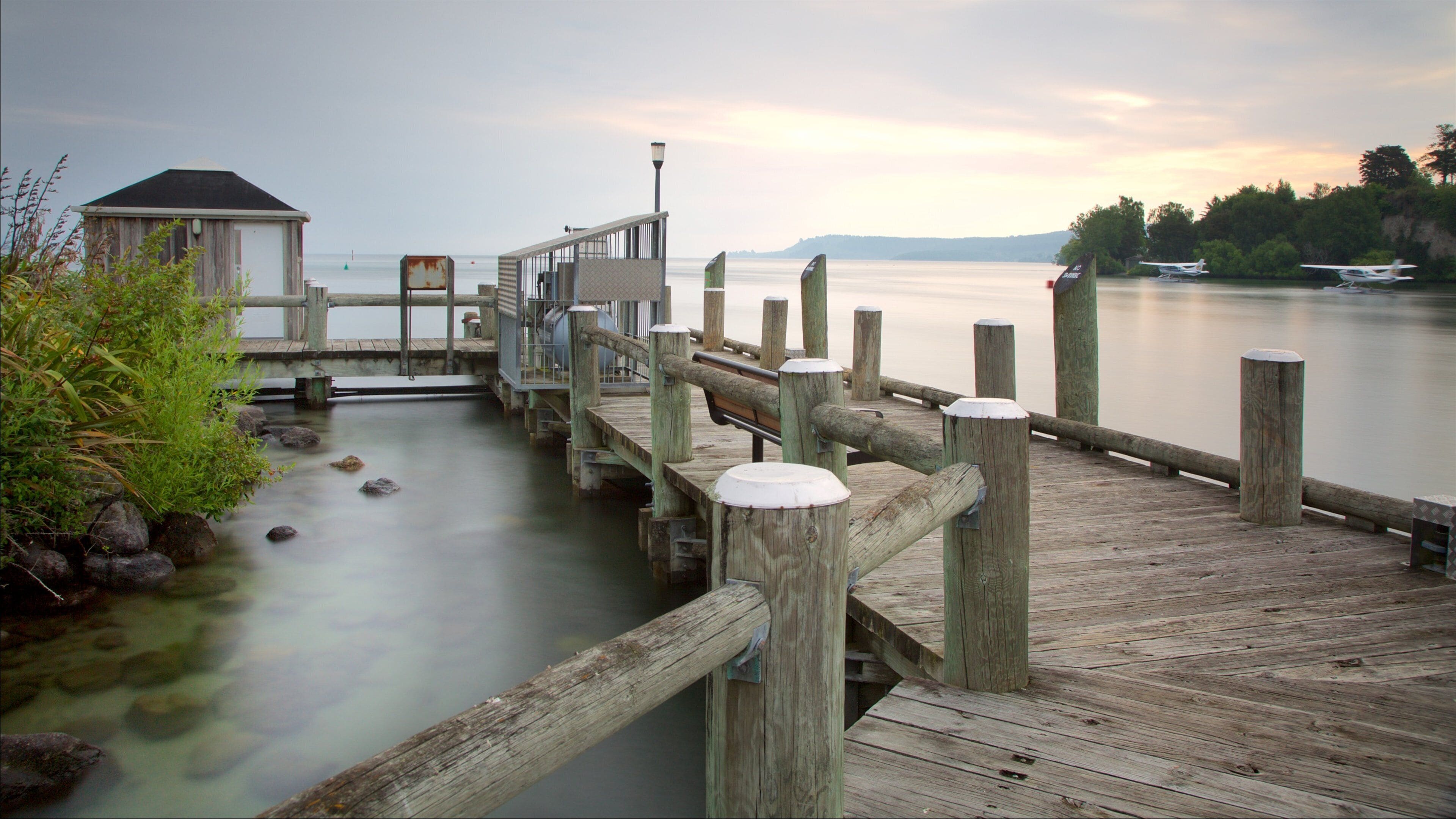 Lake Taupo which includes a sunset, aircraft and a lake or waterhole