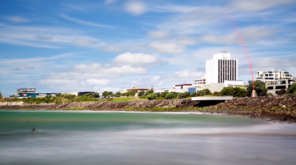 Taranaki showing a bay or harbor and rugged coastline
