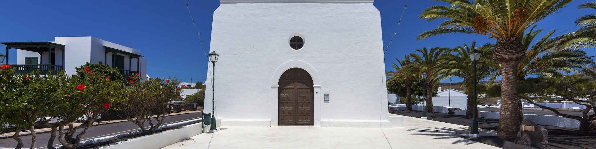 A white church with a bell tower and arched entrance.