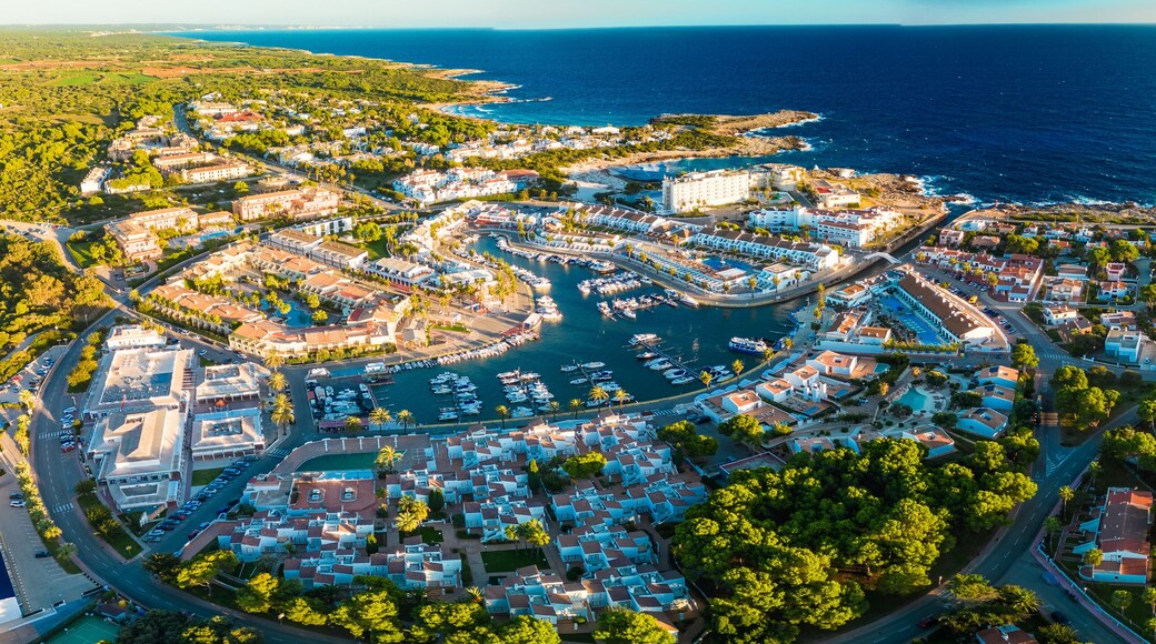 Aerial drone view of the harbor and the beach of Cala en Bosc, Menorca.