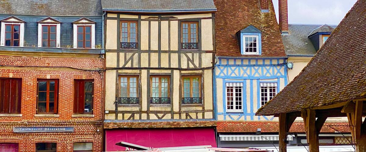 A row of colorful half-timbered buildings with distinct architectural styles.