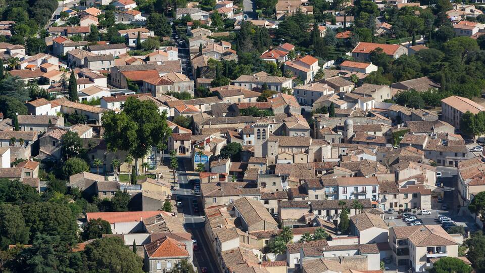 A densely packed residential area with terracotta-roofed houses and narrow streets.