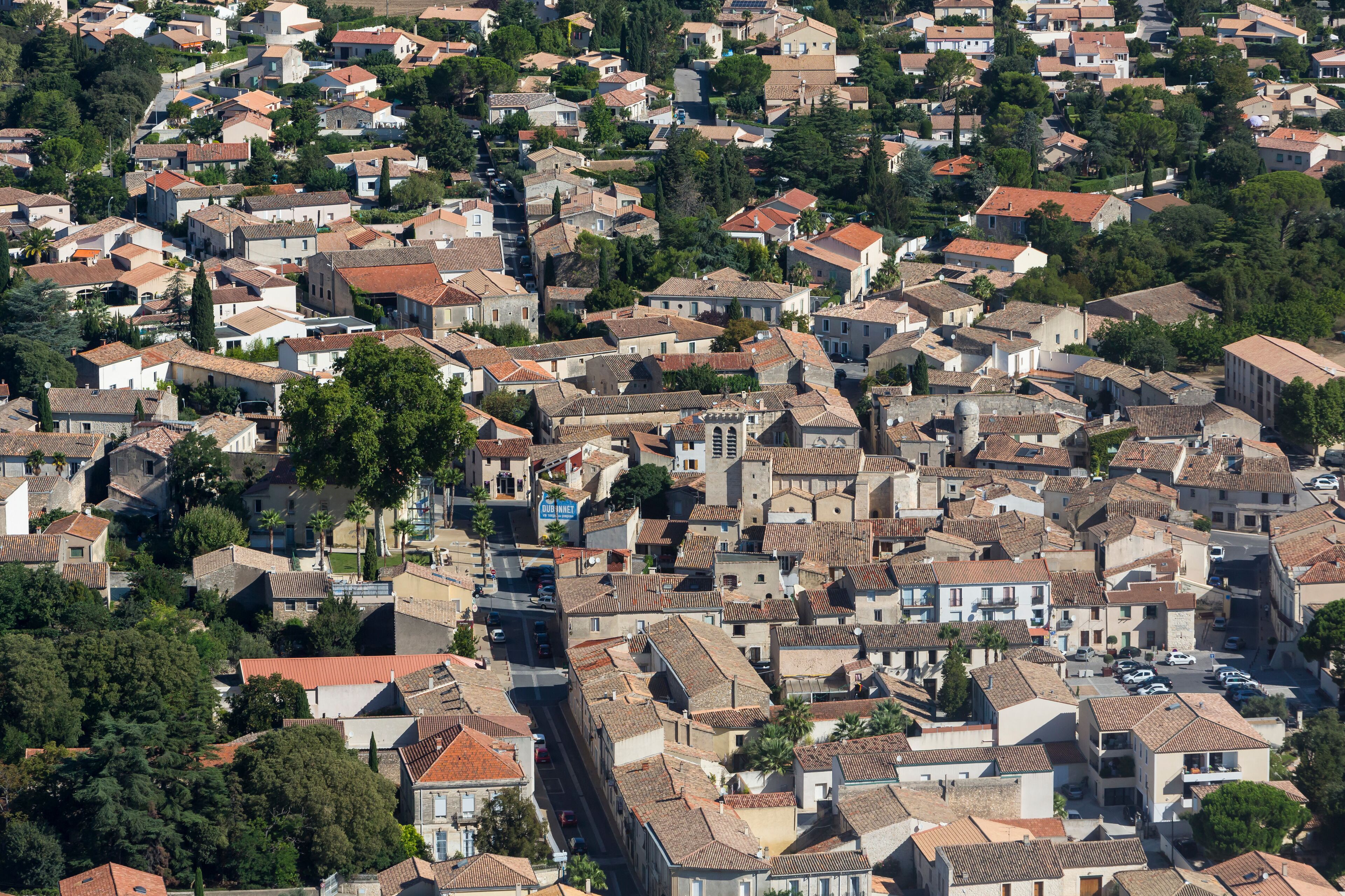 A densely packed residential area with terracotta-roofed houses and narrow streets.