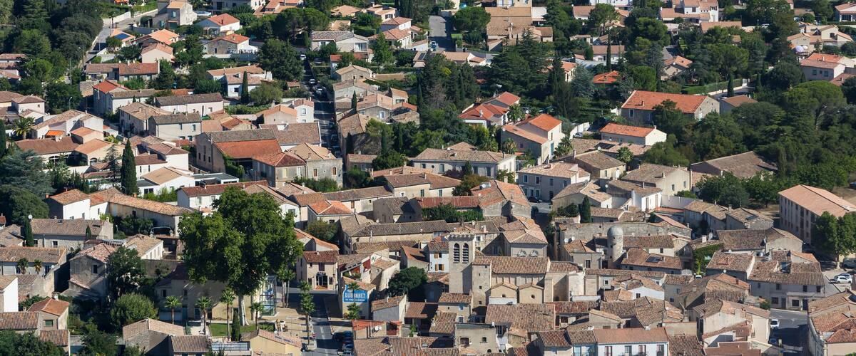 A densely packed residential area with terracotta-roofed houses and narrow streets.