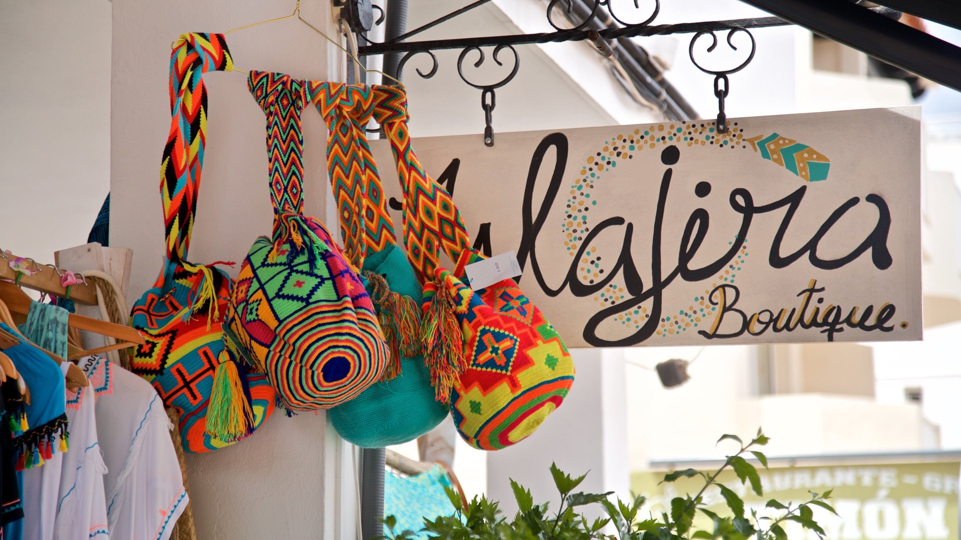 Es Pujols featuring signage and shopping