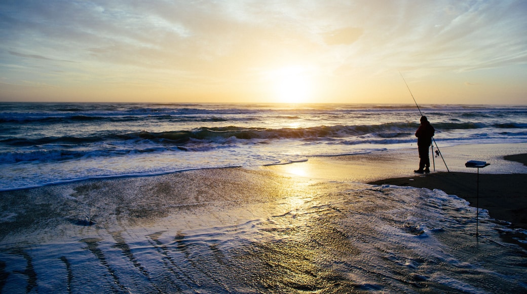 Silhouette of a Fisherman on the beach at sunset, Pescia Romana, Lazio, Italy