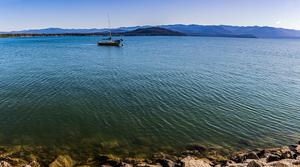 Yellow Sailboat on Lake Pend d' Oreille With Mountains From Pend d’ Oreille Bay Trail , Sandpoint, Idaho, USA