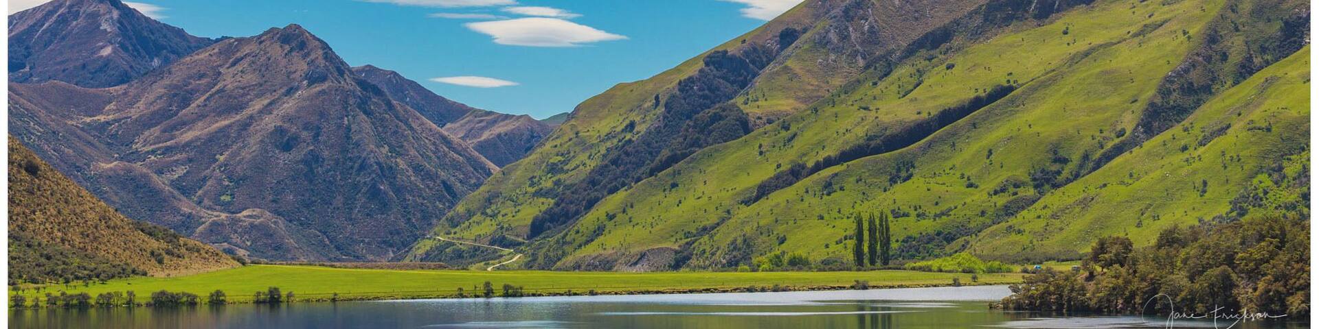 A mountainous landscape with a lake and a clear sky.