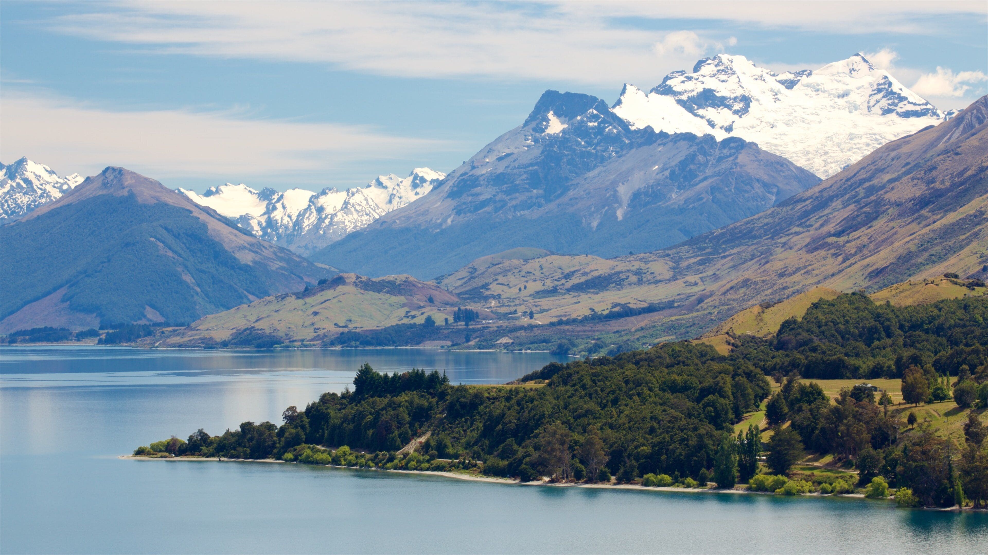 A lake surrounded by mountains with snow-capped peaks.