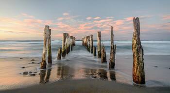 These piers are all that is left of a sea wall which has long since disappeared.
They are located at the western end of a long sandy beach, close to shops and cafes, and a salt water swimming pool