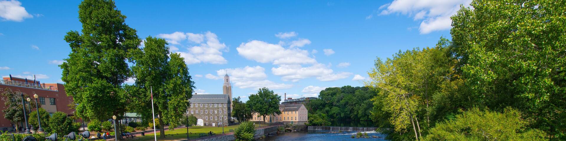 Old Slater Mill National Historic Landmark and Pawtucket Falls on Blackstone River in downtown Pawtucket, Rhode Island RI, USA.