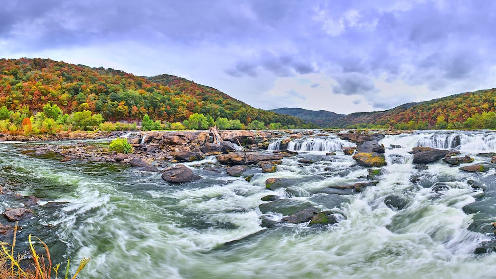 Panorama of Sandstone Falls in West Virginia with fall colors.