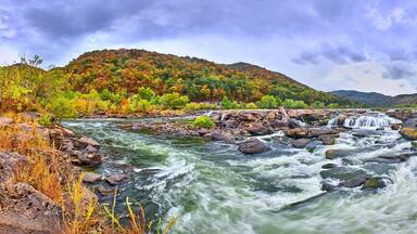 Panorama of Sandstone Falls in West Virginia with fall colors.
