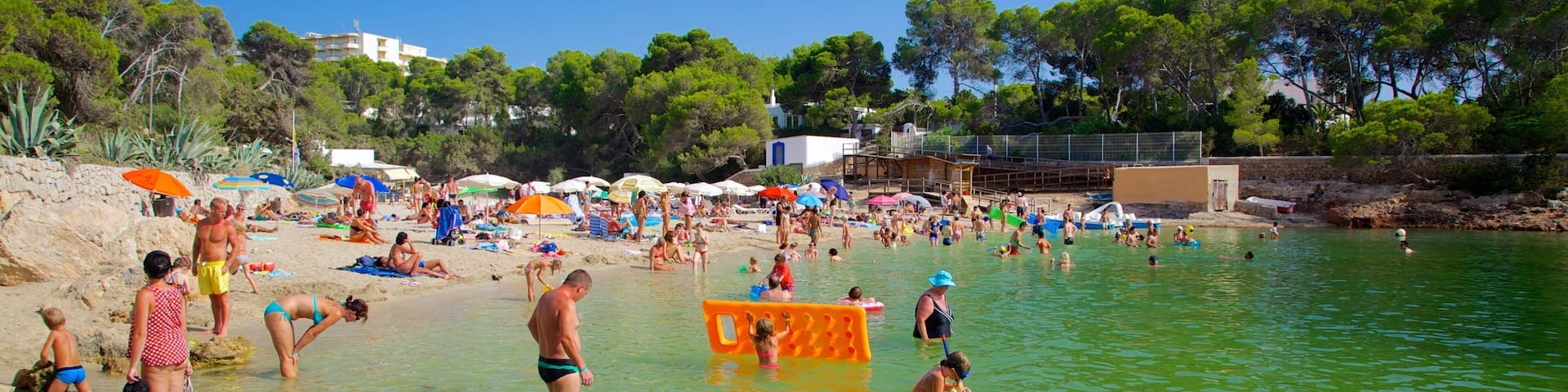 Cala Gracio featuring swimming, a sandy beach and a coastal town