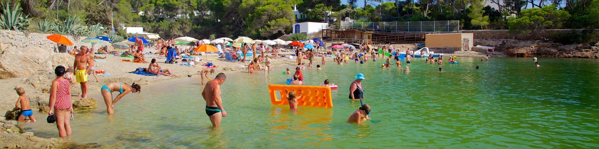 Cala Gracio featuring swimming, a sandy beach and a coastal town