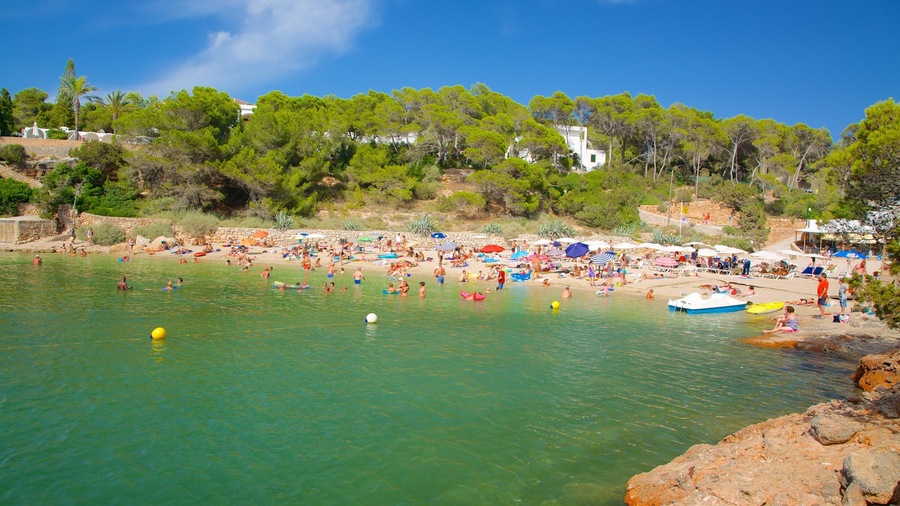 Cala Gracio showing a coastal town, a beach and swimming