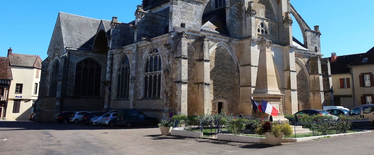 A historic church with Gothic architecture, including pointed arches and a cross on top.