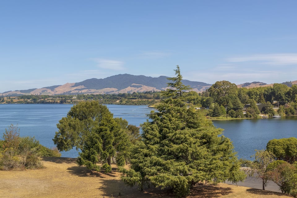 A lake surrounded by trees and hills.