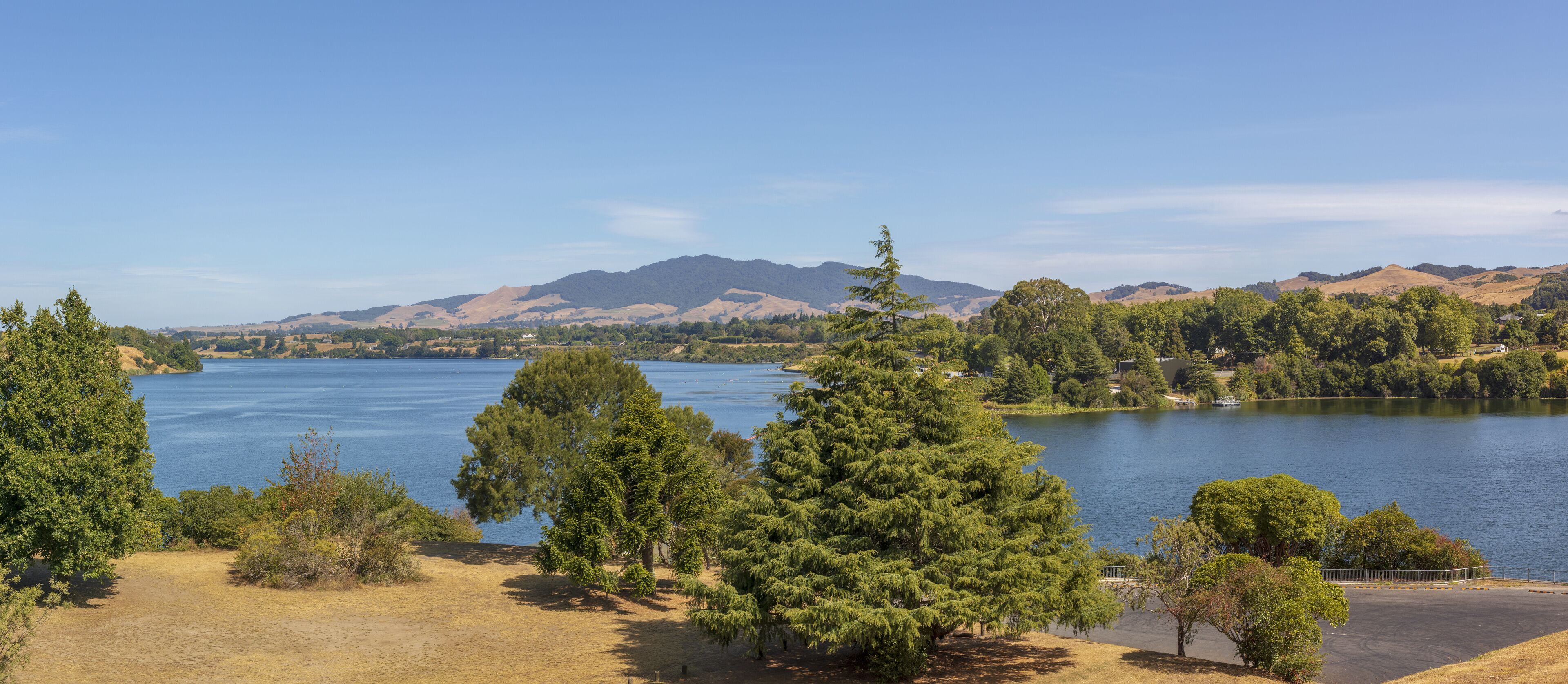 A lake surrounded by trees and hills.
