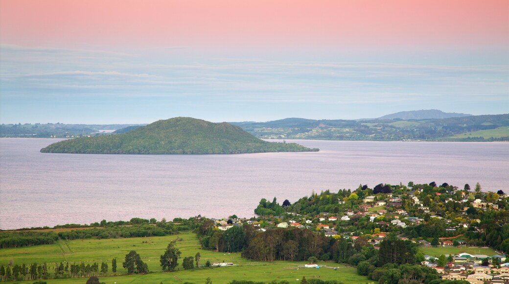 Mokoia Island featuring a sunset, a small town or village and a lake or waterhole
