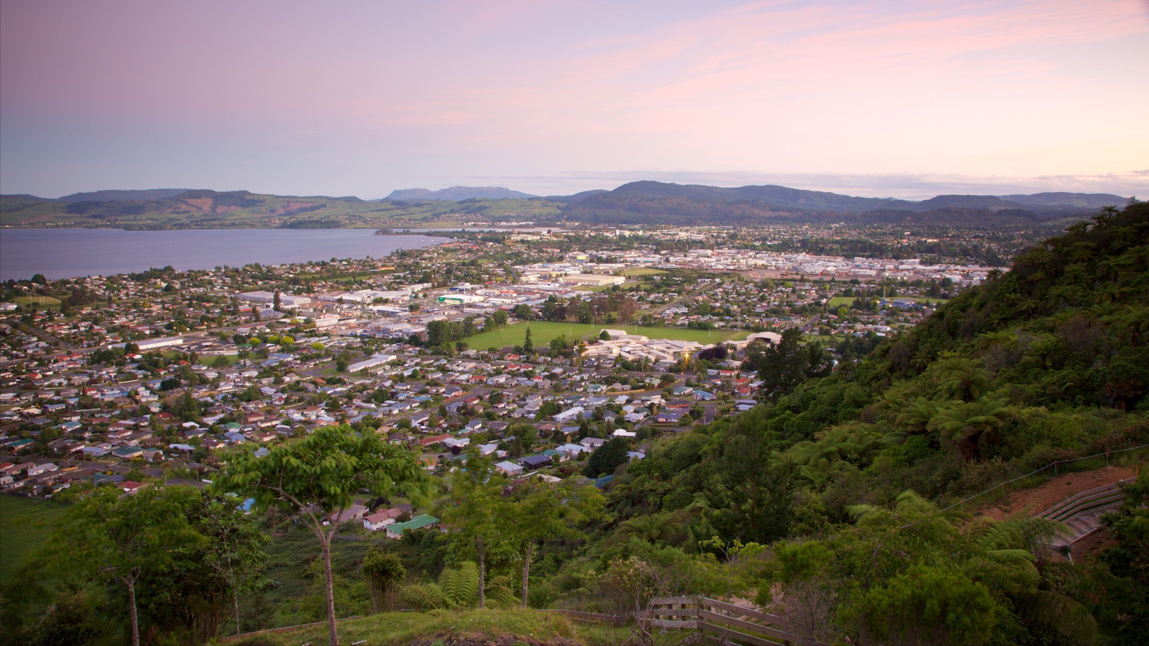 Mokoia Island featuring a sunset, a small town or village and a lake or waterhole