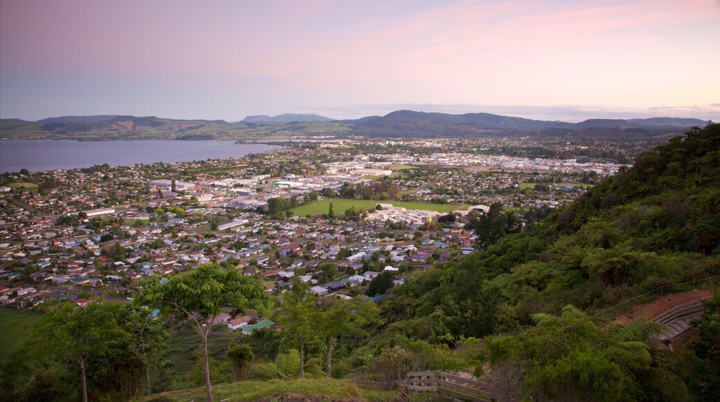Mokoia Island featuring a sunset, a small town or village and a lake or waterhole