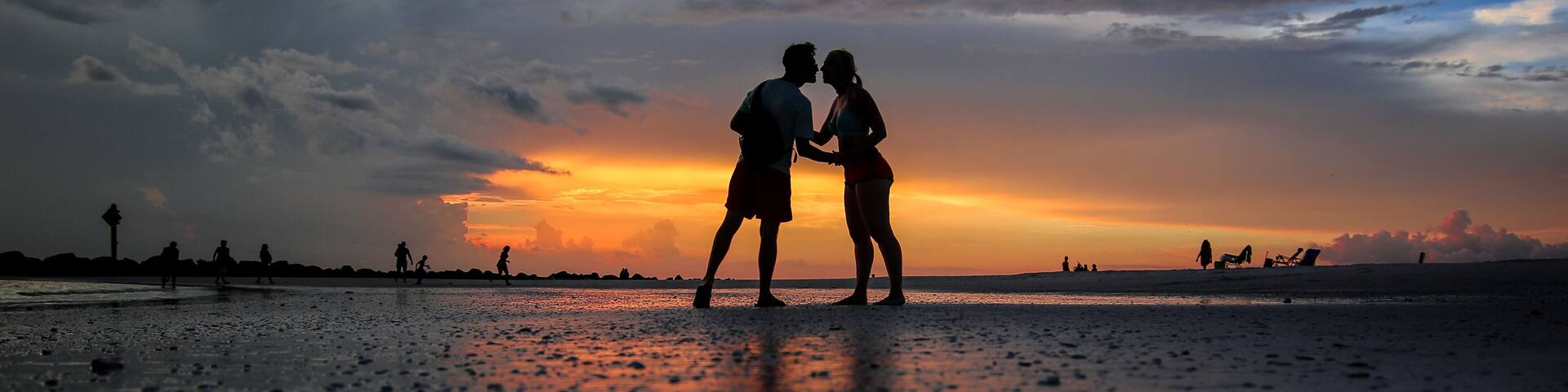 Silhouettes of a couple kissing on a beach at Honeymoon Island State Park near Clearwater, Florida