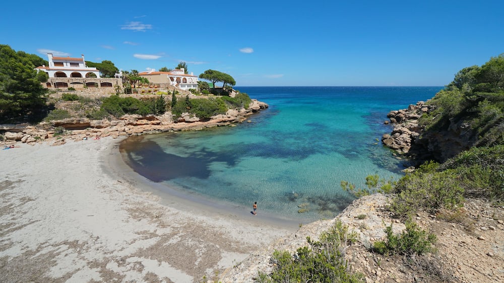 Spain Costa Dorada peaceful cove with sandy beach and coastal houses, Mediterranean sea, Cala Estany Tort, Catalonia, L'Ametlla de Mar, Tarragona