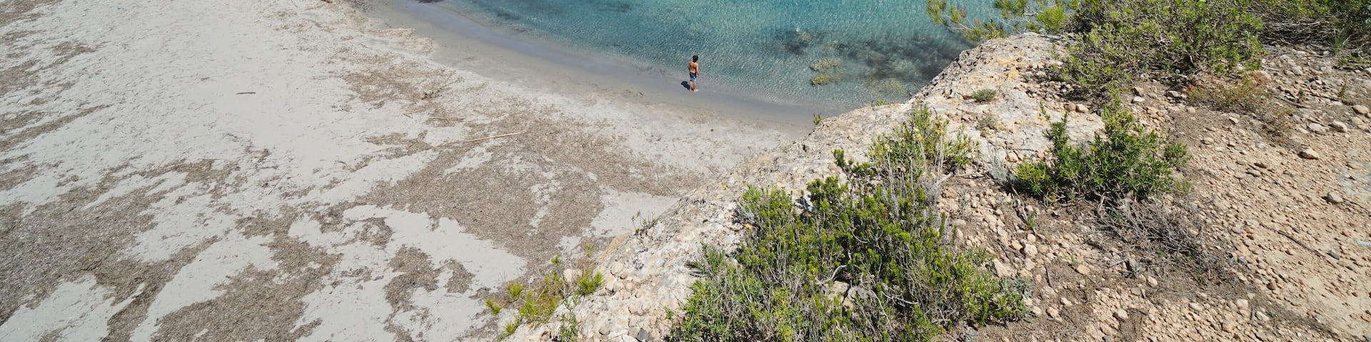 Spain Costa Dorada peaceful cove with sandy beach and coastal houses, Mediterranean sea, Cala Estany Tort, Catalonia, L'Ametlla de Mar, Tarragona