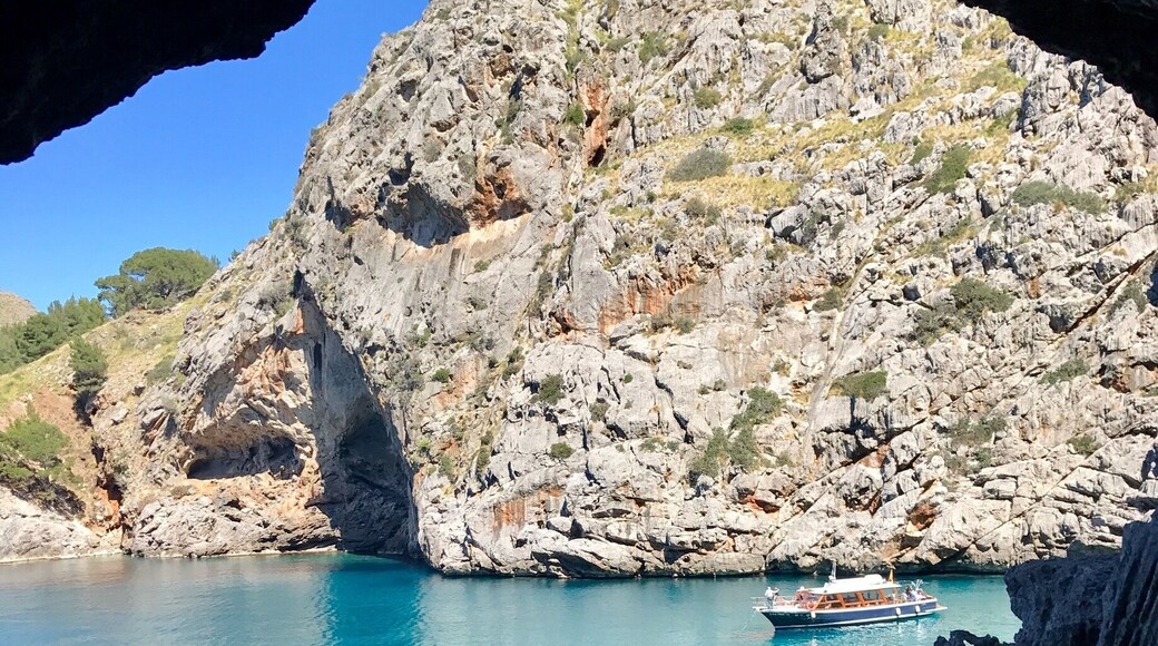 Sa Calobra, is a gorgeous pebble beach in northern Mallorca.The path leading to the beach is quite interesting as you walk through pitch dark damp tunnels. This is the first glimpse of the beach through an opening in one of the tunnels!