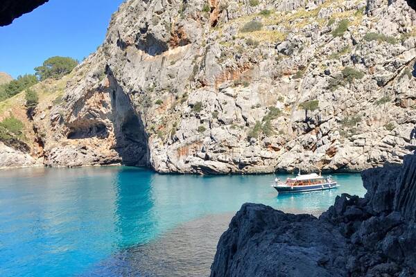 Sa Calobra, is a gorgeous pebble beach in northern Mallorca.The path leading to the beach is quite interesting as you walk through pitch dark damp tunnels. This is the first glimpse of the beach through an opening in one of the tunnels!