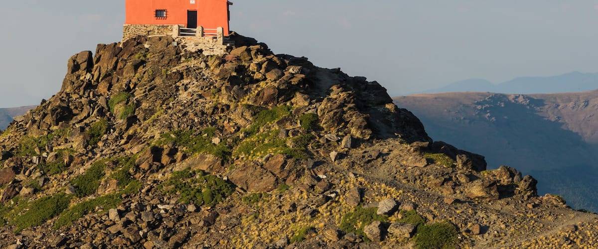 The observatorio Mohon del Trigo is an observatory, which was built in in 1902 and contained a 32 cm Cassegrain type KYOTO reflector telescope donated by Georgetown University. It is located in the vicinity of Pico del Veleta (3394m) in the Sierra Nevada mountain range in Spain at a height of about 2600m. The observatory was abandoned in the 1970s and deterioated into a ruin as documented by me in 2010. Since then, the observatory has been restored and is today in good shape (as seen from the outside, at least, I have not been inside). Nearby is also barracks used by the Special Operations Command of Spain. Here, the observatory is seen in evening sun as viewed from nearby Monument of Our Lady of the Snows. From this view point, the modern Sierra Nevada Observatory established 1981 can also be seen, but in the opposite direction.(Thanks to Slaunger for his excellent caption of his Featured Picture of the same building, I've almost copied and pasted...