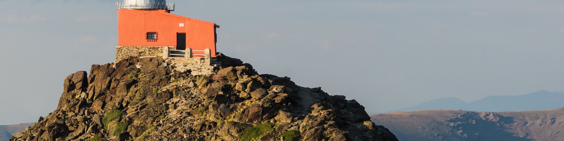 The observatorio Mohon del Trigo is an observatory, which was built in in 1902 and contained a 32 cm Cassegrain type KYOTO reflector telescope donated by Georgetown University. It is located in the vicinity of Pico del Veleta (3394m) in the Sierra Nevada mountain range in Spain at a height of about 2600m. The observatory was abandoned in the 1970s and deterioated into a ruin as documented by me in 2010. Since then, the observatory has been restored and is today in good shape (as seen from the outside, at least, I have not been inside). Nearby is also barracks used by the Special Operations Command of Spain. Here, the observatory is seen in evening sun as viewed from nearby Monument of Our Lady of the Snows. From this view point, the modern Sierra Nevada Observatory established 1981 can also be seen, but in the opposite direction.(Thanks to Slaunger for his excellent caption of his Featured Picture of the same building, I've almost copied and pasted...