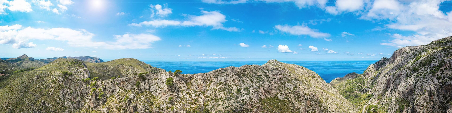 A mountainous landscape with rocky terrain and a winding road.