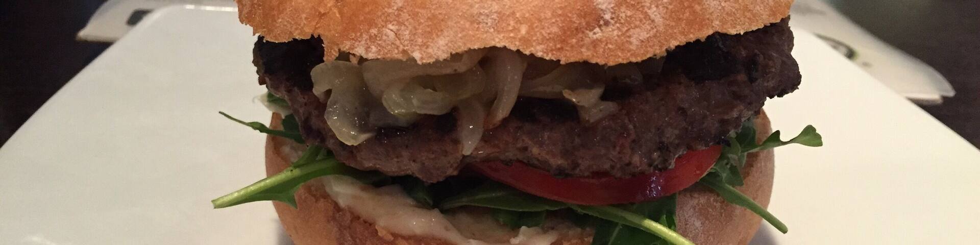 My first time trying a kangaroo burger. Served with caramelized onions, greens, tomatoes, and beetroot relish. Pretty good.