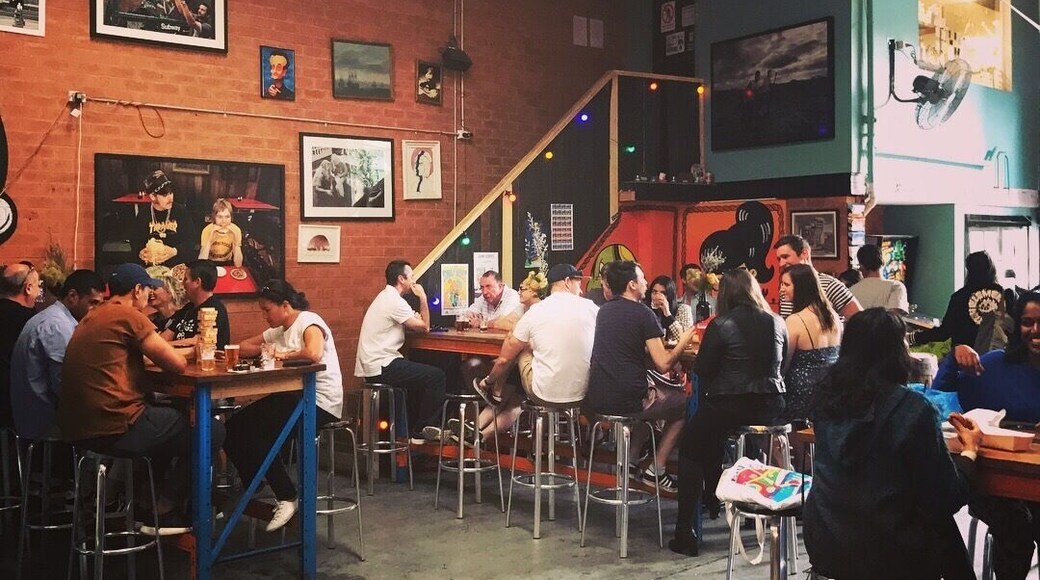 More hipsters drinking in a cool craft beer spot.