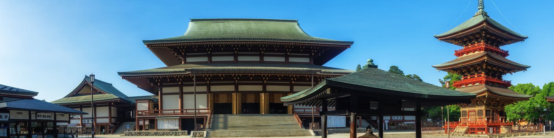 view of Naritasan temple with red pagoda and blue sky in Naritasan Shinshoji temple at Chiba Prefecture.