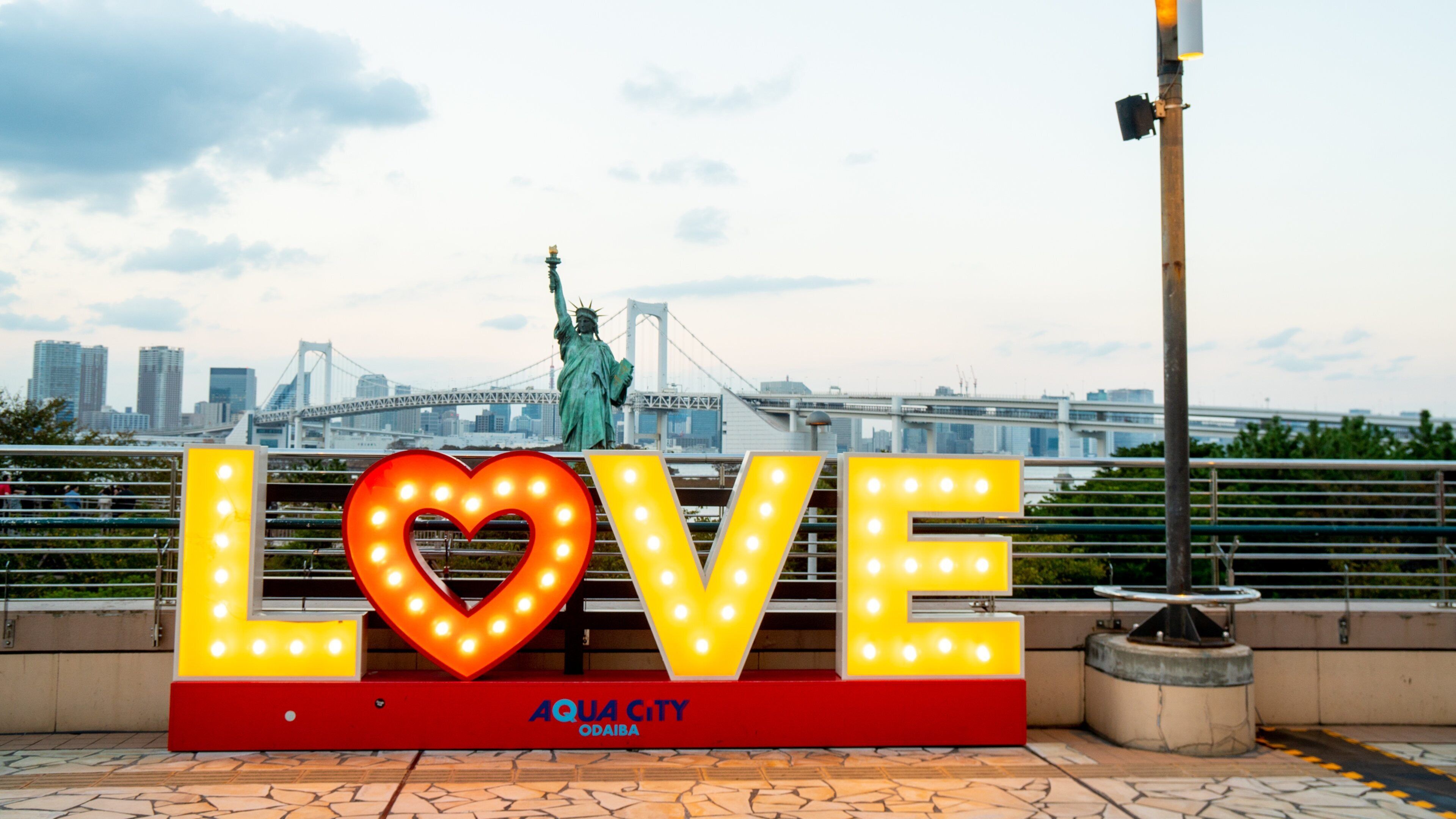 Odaiba featuring a monument, a sunset and signage