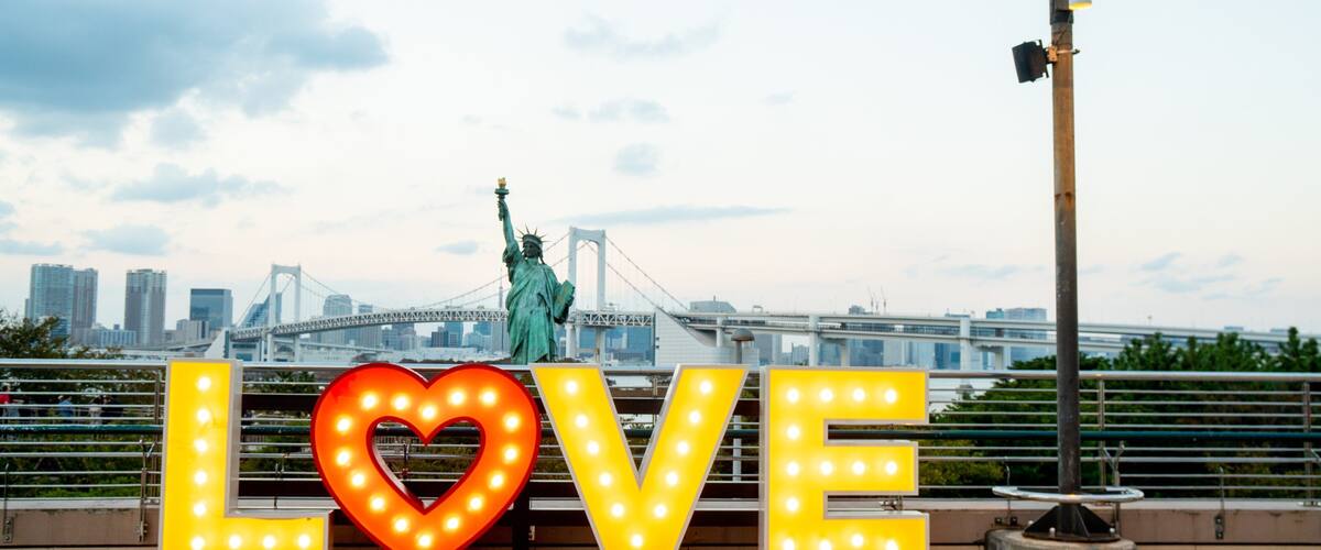 Odaiba featuring a monument, a sunset and signage