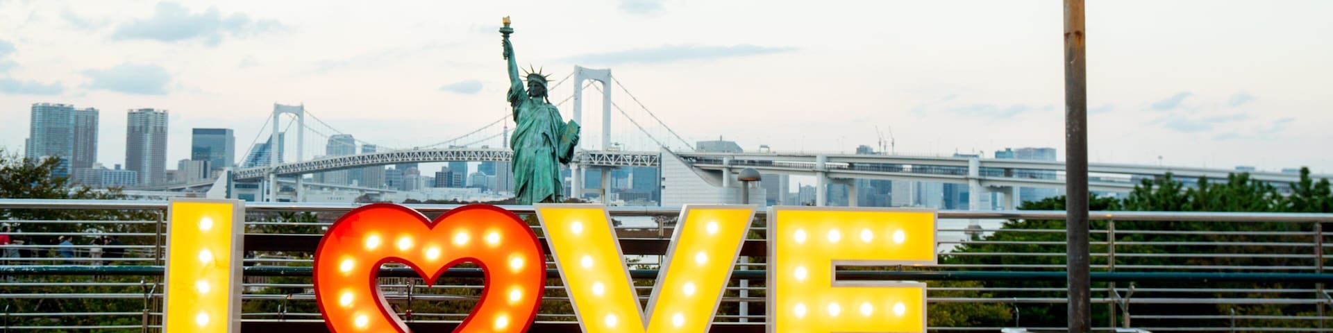 Odaiba featuring a monument, a sunset and signage