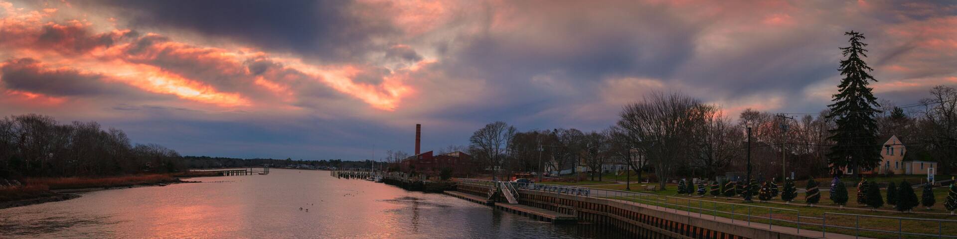 Dramatic cloudscape at sunrise over the coastal village and canal in Wareham, Massachusetts.