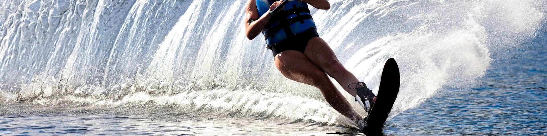 A female water skier rips a turn causing a huge water spray while skiing on Cobbosseecontee Lake near Monmouth, Maine.