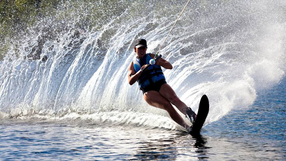 A person wakeboarding on a wave.
