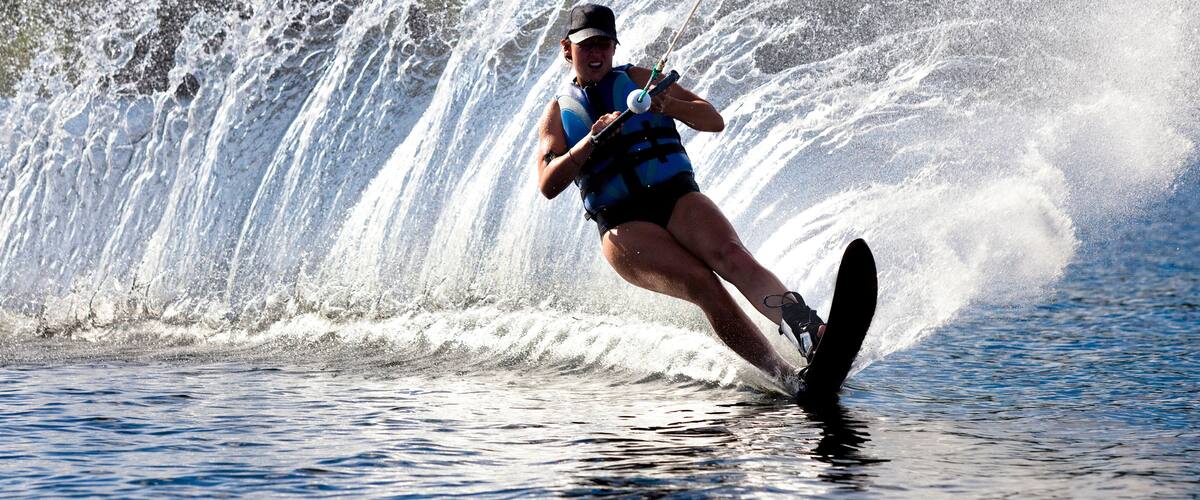 A person wakeboarding on a wave.