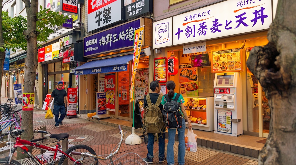 Kannai featuring signage and street scenes as well as a couple