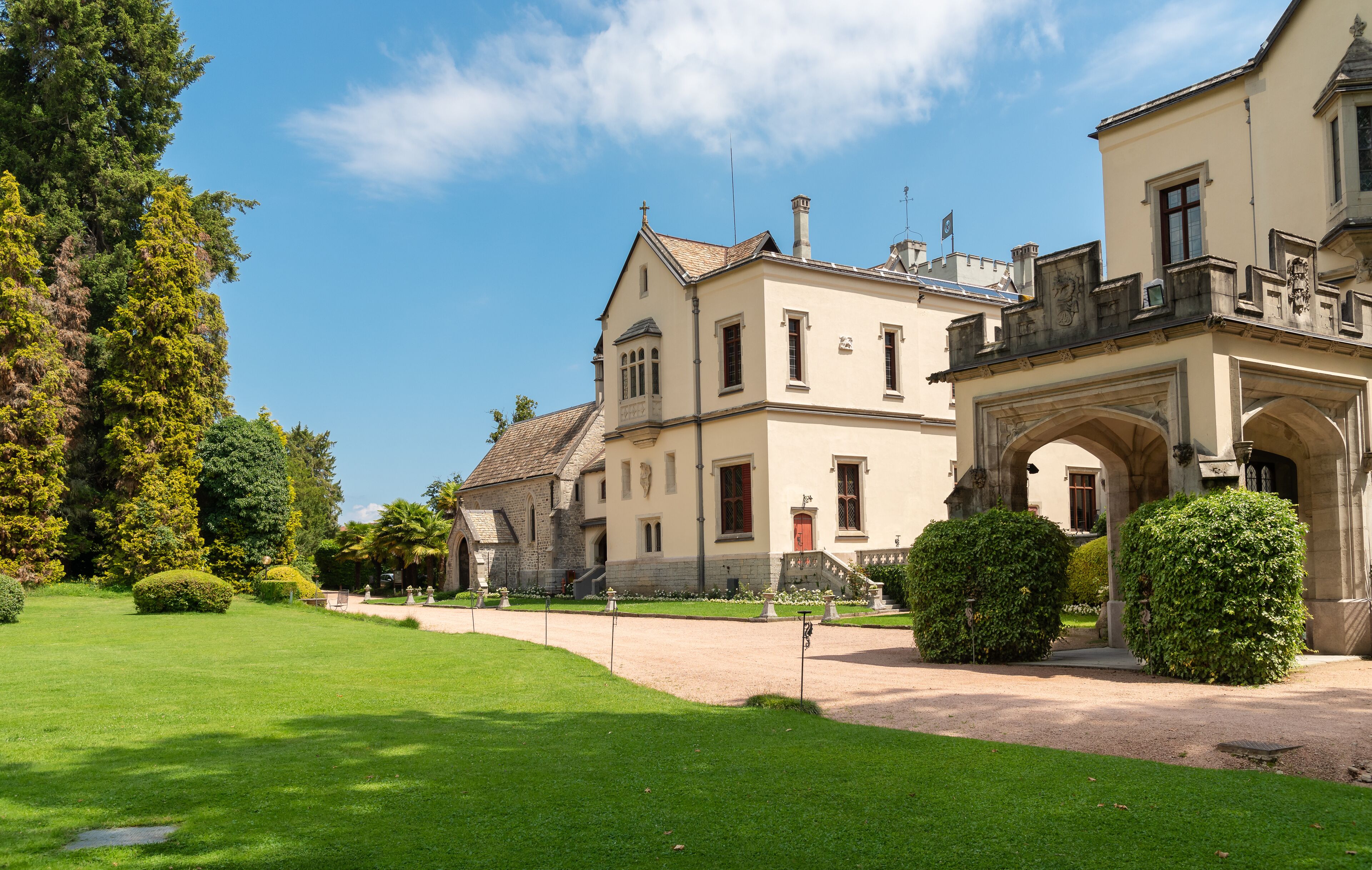 A historic building with a well-manicured lawn and an ornate entrance.