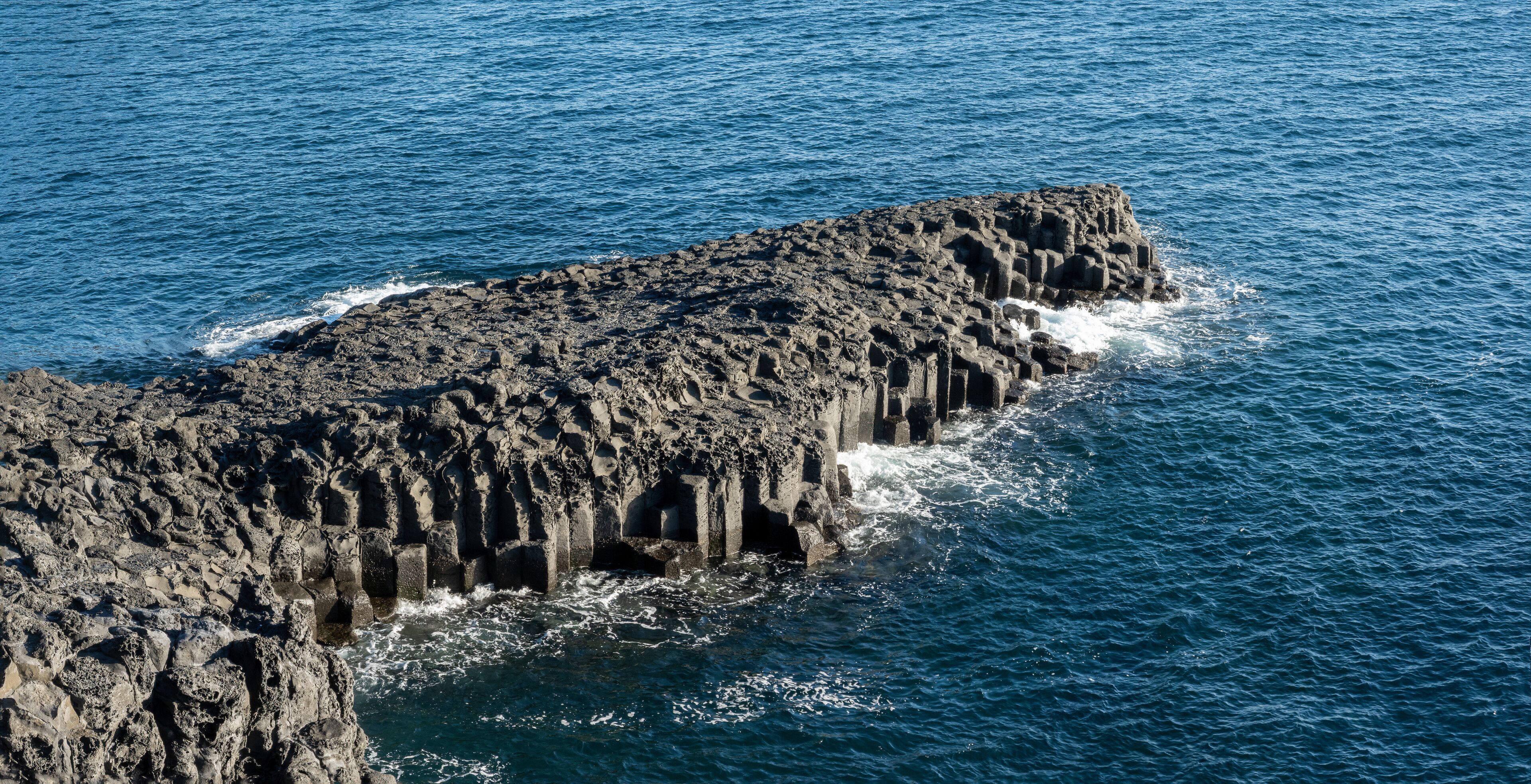 Promontory at Jusangjeolli Cliffs (Daepo Haean), with stunning hexagonal basalt columns formed by lava cooling in the sea, Seogwipo, Jeju island, South Korea