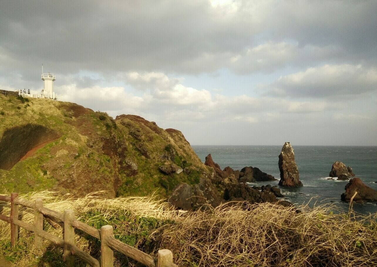 The famous lighthouse at Seopjikoji Coast, Jeju. Very windy.