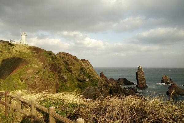 The famous lighthouse at Seopjikoji Coast, Jeju. Very windy.