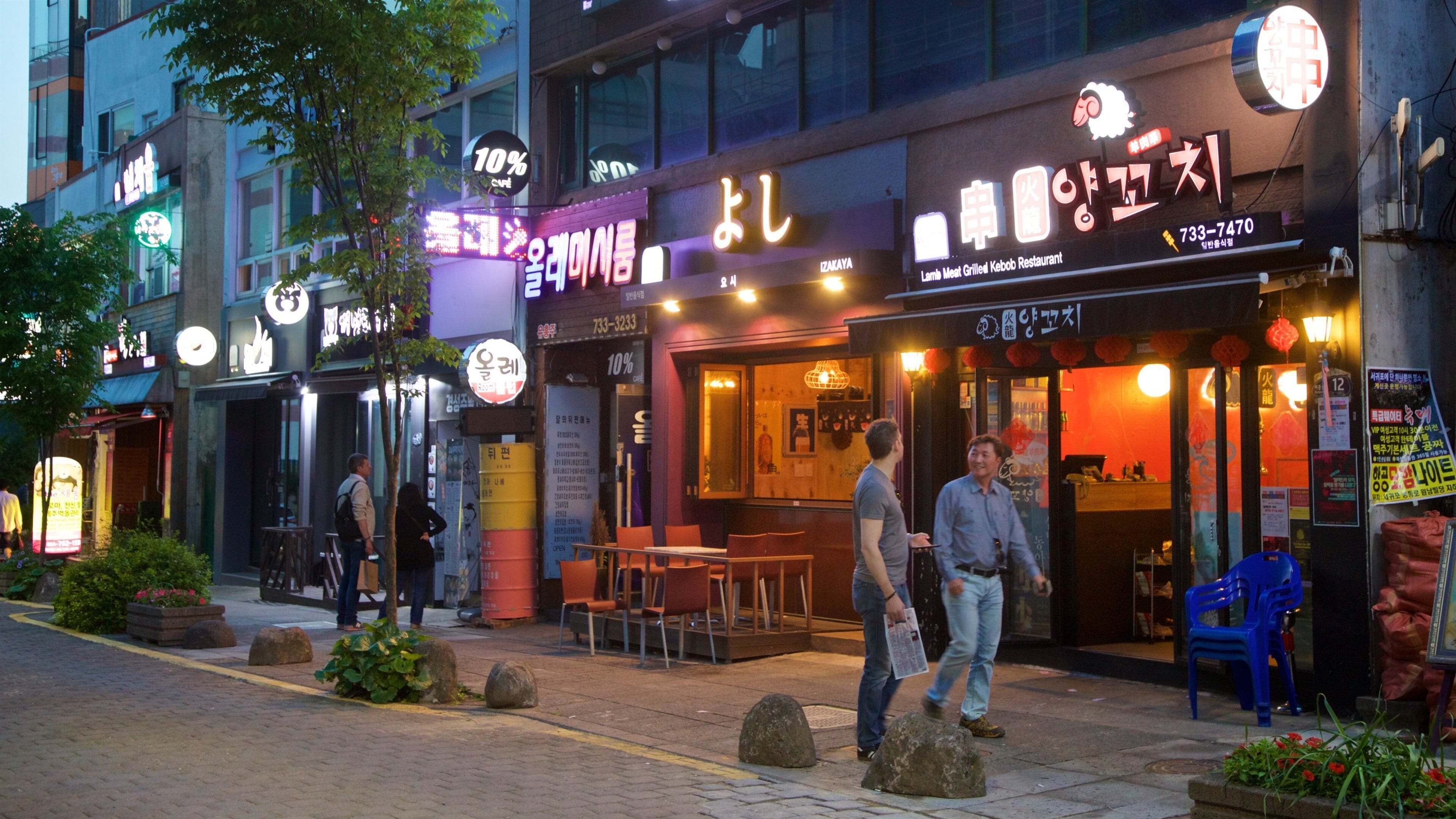 Seogwipo showing night scenes and street scenes as well as a couple